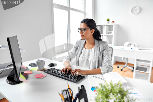 Image of businesswoman with computer working at office