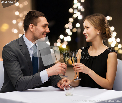 Image of couple with glasses of champagne at restaurant