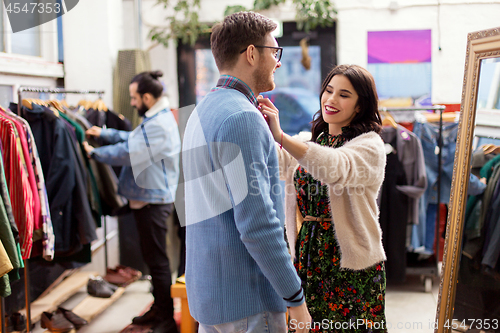 Image of couple choosing clothes at vintage clothing store