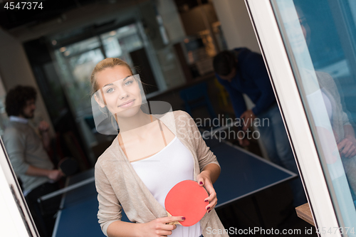 Image of startup business team playing ping pong tennis