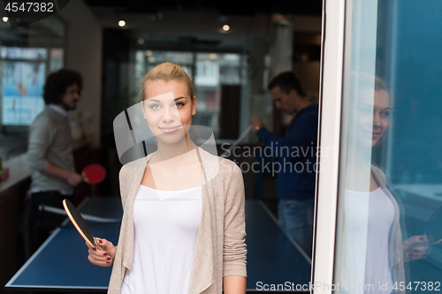 Image of startup business team playing ping pong tennis