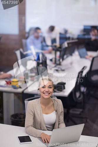 Image of businesswoman using a laptop in startup office