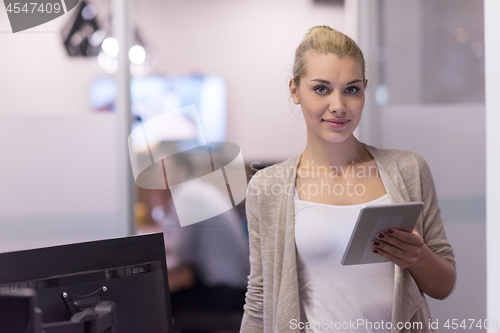 Image of Business Woman Using Digital Tablet in front of startup Office