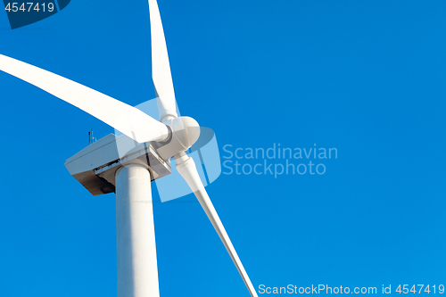 Image of Single Wind Turbine Over Dramatic Blue Sky