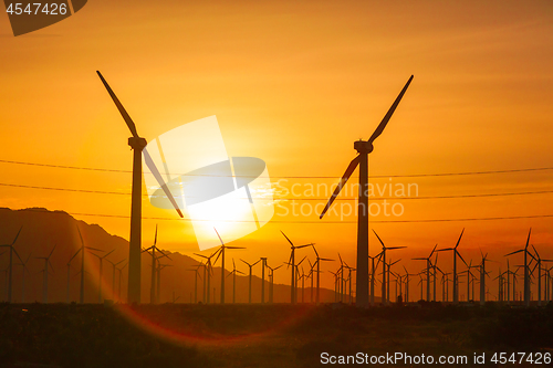 Image of Silhouetted Wind Turbines Over Dramatic Sunset Sky