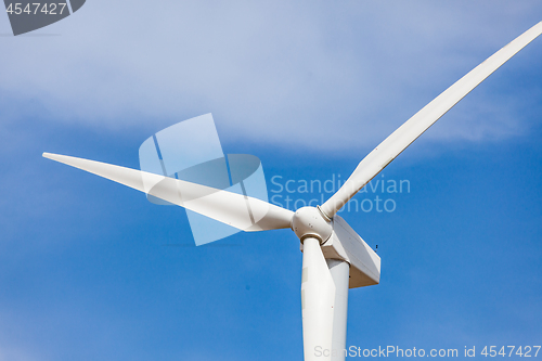 Image of Single Wind Turbine Over Dramatic Blue Sky