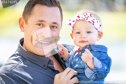 Image of Young Caucasian Father and Baby Girl At The Park