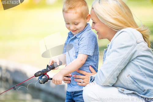 Image of Young Caucasian Mother and Son Having Fun Fishing At The Lake