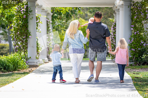 Image of Young Caucasian Family Taking A Walk In The Park