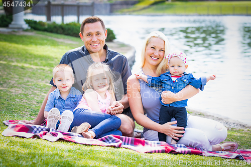 Image of Happy Young Caucasian Family Portrait In The Park