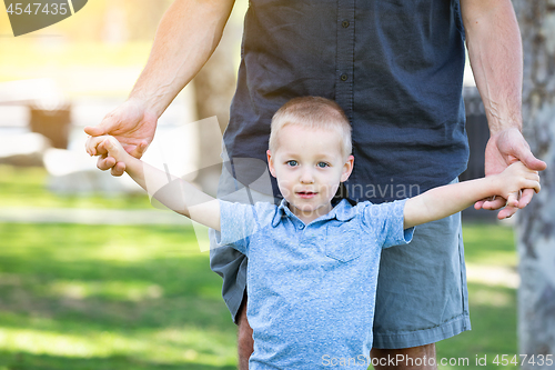 Image of Young Caucasian Father and Son Having Fun At The Park