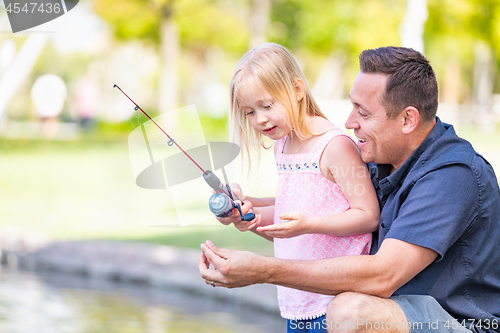 Image of Young Caucasian Father and Daughter Having Fun Fishing At The La