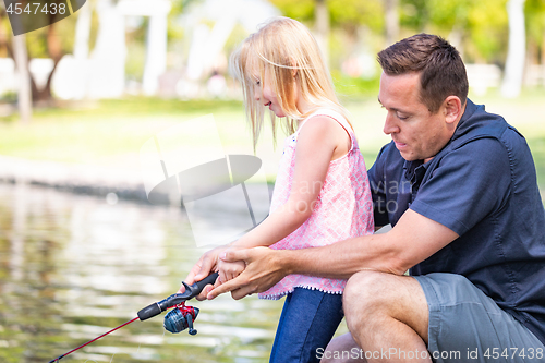 Image of Young Caucasian Father and Daughter Having Fun Fishing At The La