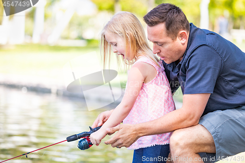 Image of Young Caucasian Father and Daughter Having Fun Fishing At The La