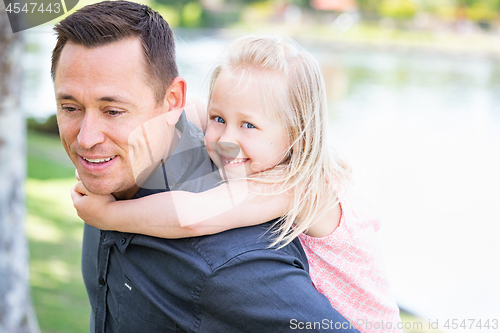 Image of Young Caucasian Father and Daughter Having Fun At The Park