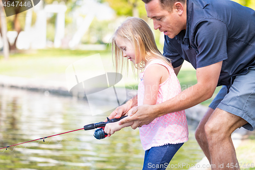 Image of Young Caucasian Father and Daughter Having Fun Fishing At The La