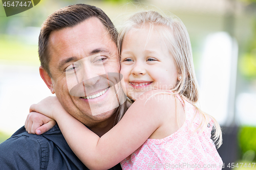 Image of Young Caucasian Father and Daughter Having Fun At The Park