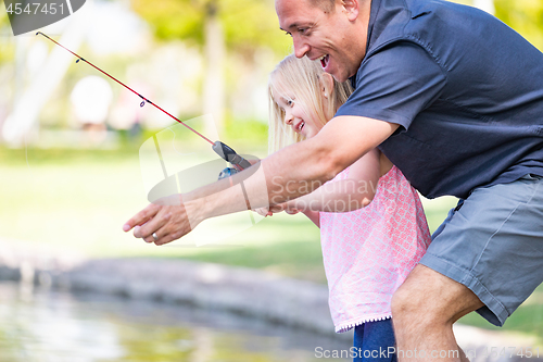 Image of Young Caucasian Father and Daughter Having Fun Fishing At The La