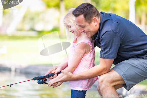 Image of Young Caucasian Father and Daughter Having Fun Fishing At The La