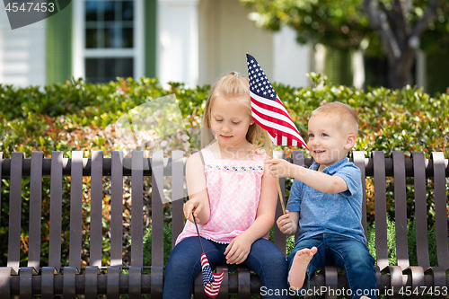 Image of Young Sister and Brother Comparing Each Others American Flag Siz