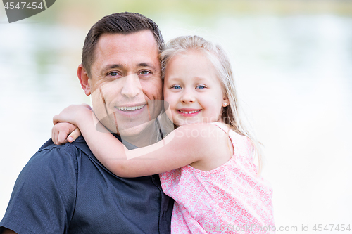 Image of Young Caucasian Father and Daughter Having Fun At The Park