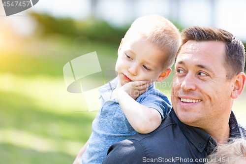 Image of Young Caucasian Father and Son Having Fun At The Park