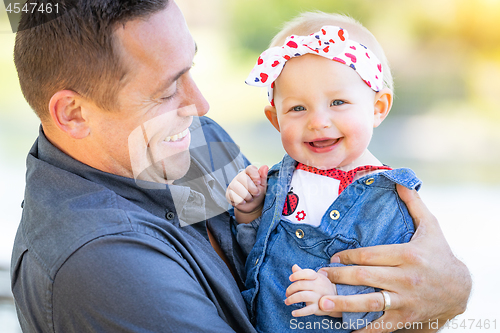 Image of Young Caucasian Father and Baby Girl At The Park