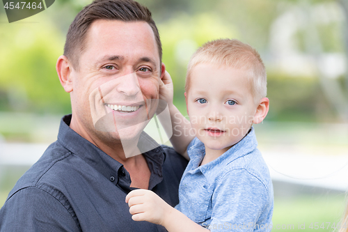 Image of Young Caucasian Father and Son Having Fun At The Park