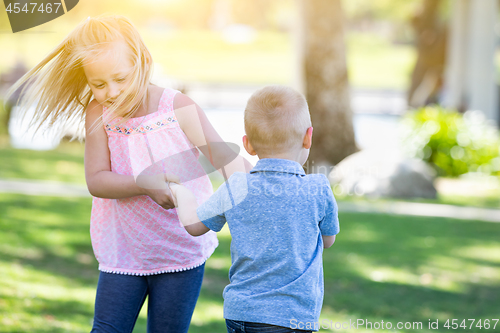 Image of Young Brother and Sister Playing At The Park Togther