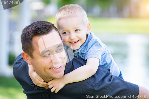 Image of Young Caucasian Father and Son Having Fun At The Park