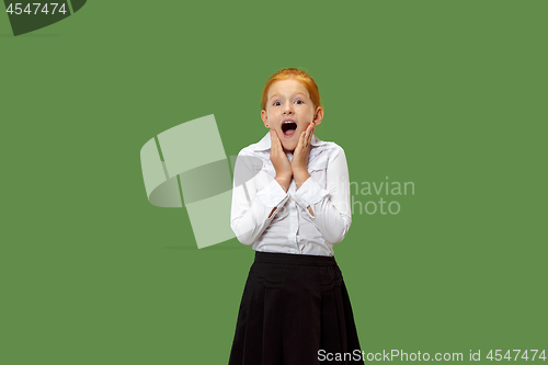 Image of Beautiful teen girl looking suprised isolated on green