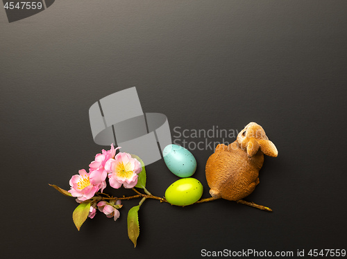 Image of a happy easter decoration with a bunny eggs and blossoms