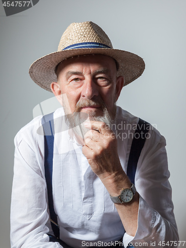 Image of senior male portrait with a straw hat