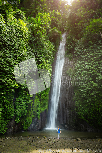Image of girl watching a waterfall in Bali Indonesia