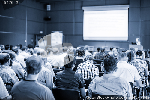 Image of Speaker giving presentation on scientific business conference.