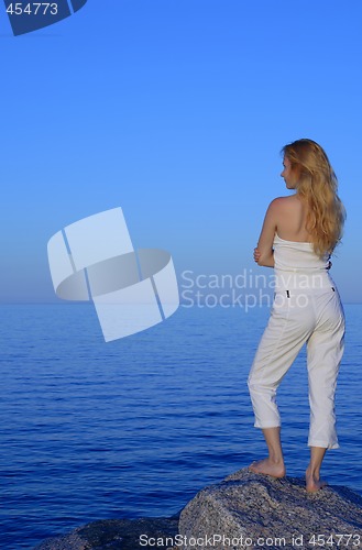 Image of Calm young woman looking at the sea