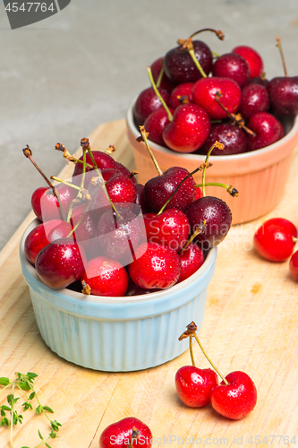 Image of Red ripe cherries in ceramic bowls