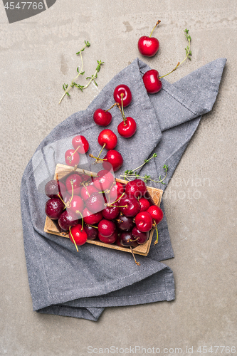 Image of Red ripe cherries in small wooden box