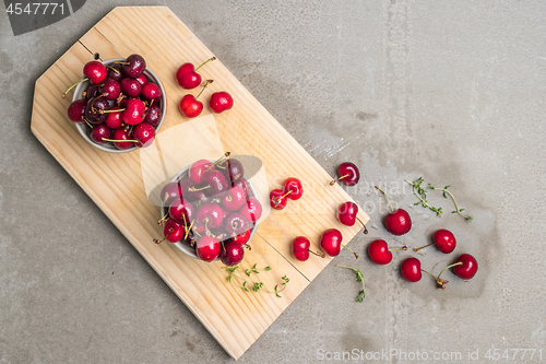 Image of Red ripe cherries in ceramic bowls