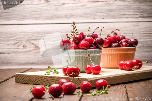 Image of Red ripe cherries in ceramic bowls