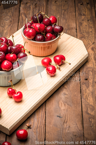 Image of Red ripe cherries in ceramic bowls