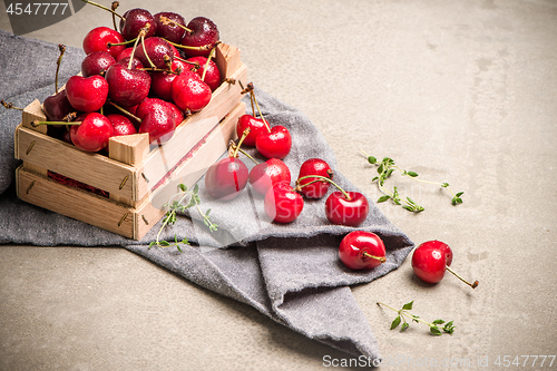 Image of Red ripe cherries in small wooden box