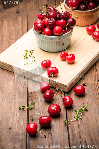 Image of Red ripe cherries in ceramic bowls