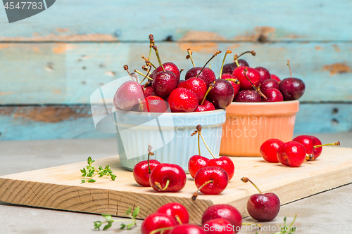 Image of Red ripe cherries in ceramic bowls