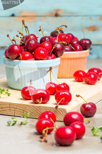 Image of Red ripe cherries in ceramic bowls