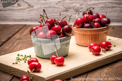 Image of Red ripe cherries in ceramic bowls