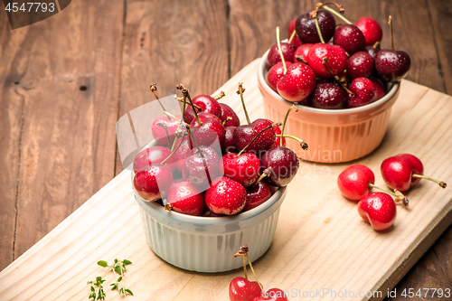 Image of Red ripe cherries in ceramic bowls