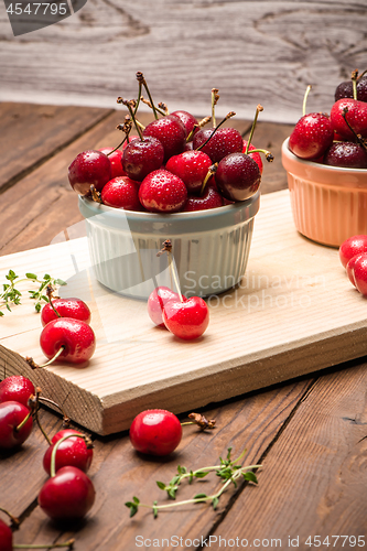 Image of Red ripe cherries in ceramic bowls