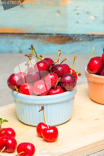 Image of Red ripe cherries in ceramic bowls