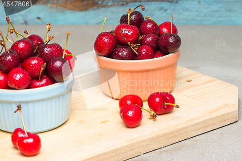 Image of Red ripe cherries in ceramic bowls